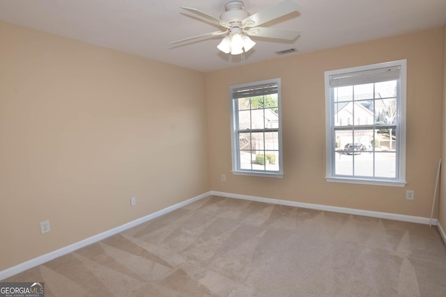 unfurnished room featuring light carpet, baseboards, and visible vents