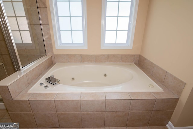 full bathroom featuring a whirlpool tub