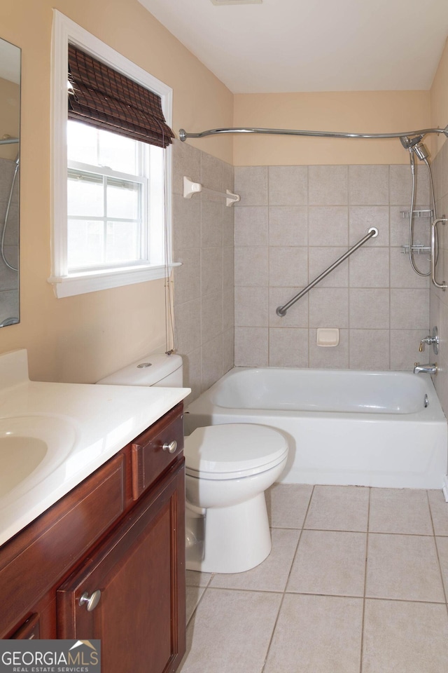 bathroom featuring toilet, bathtub / shower combination, vanity, and tile patterned floors