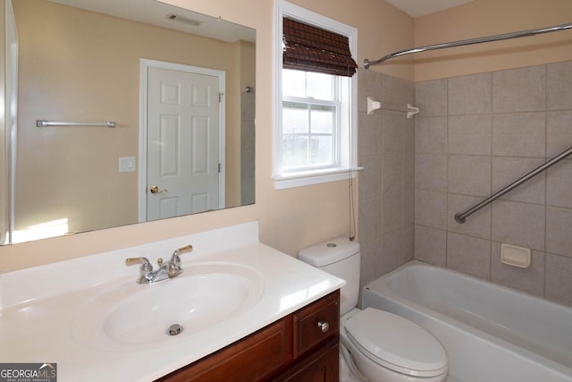 full bath with visible vents, vanity, toilet, and shower / bathtub combination