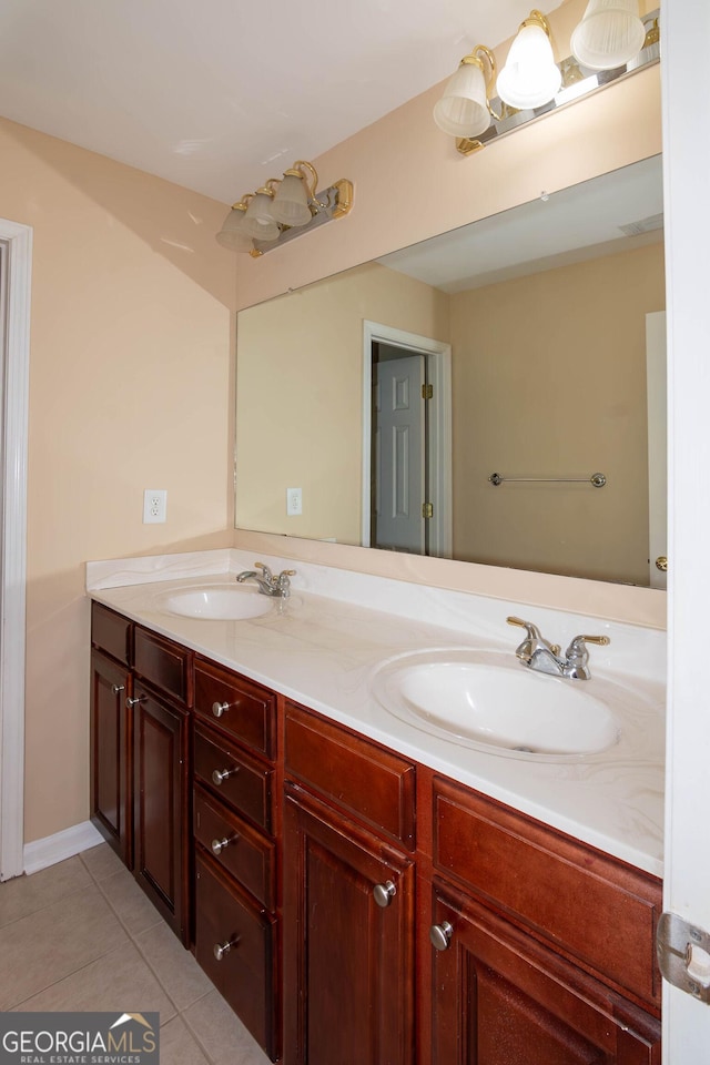 bathroom featuring double vanity, tile patterned flooring, and a sink