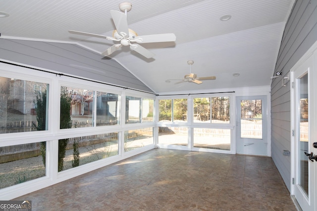 unfurnished sunroom with lofted ceiling, a ceiling fan, and a wealth of natural light