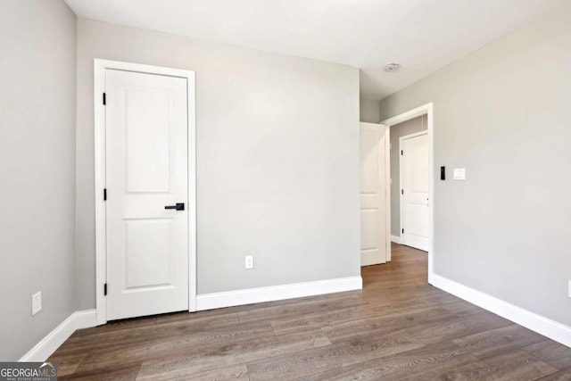 unfurnished bedroom featuring baseboards and wood finished floors