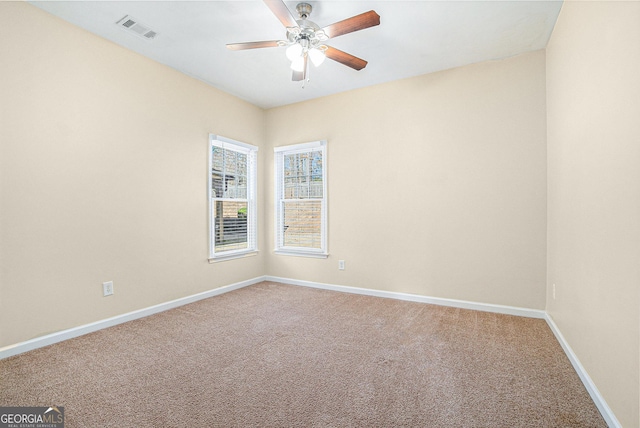 unfurnished room featuring a ceiling fan, baseboards, visible vents, and carpet flooring