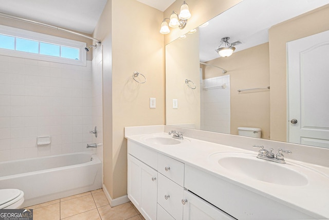 bathroom featuring tile patterned flooring, a sink, shower / bathing tub combination, and toilet