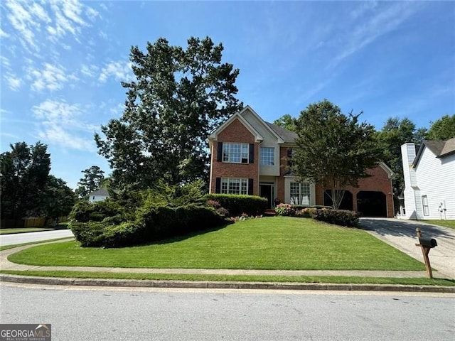 view of front of house with driveway and a front lawn