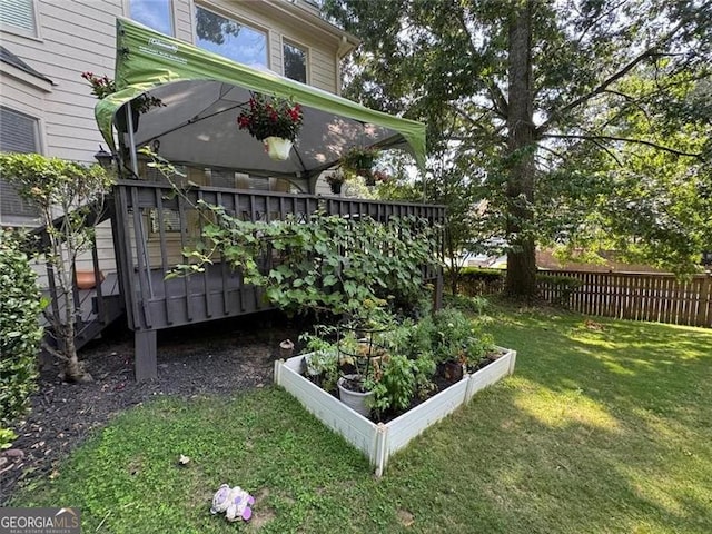 view of yard with fence and a garden