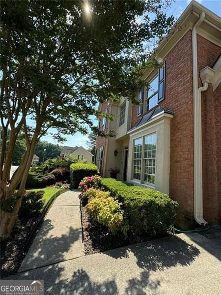 view of side of home featuring brick siding