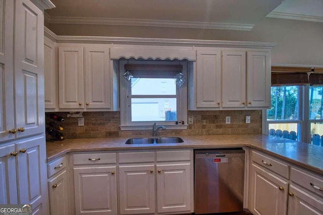 kitchen with ornamental molding, stainless steel dishwasher, a sink, and white cabinetry