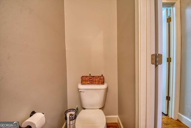 bathroom with toilet and baseboards