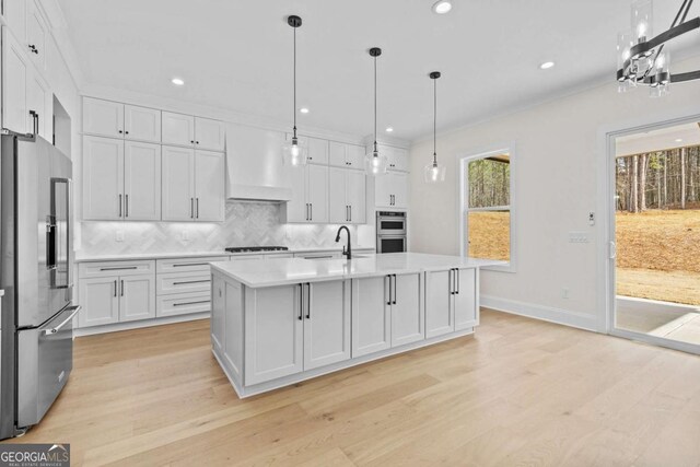 3636 Castoff Ct, Gainesville, GA 30506 - kitchen featuring decorative backsplash, appliances with stainless steel finishes, custom exhaust hood, light countertops, and a sink