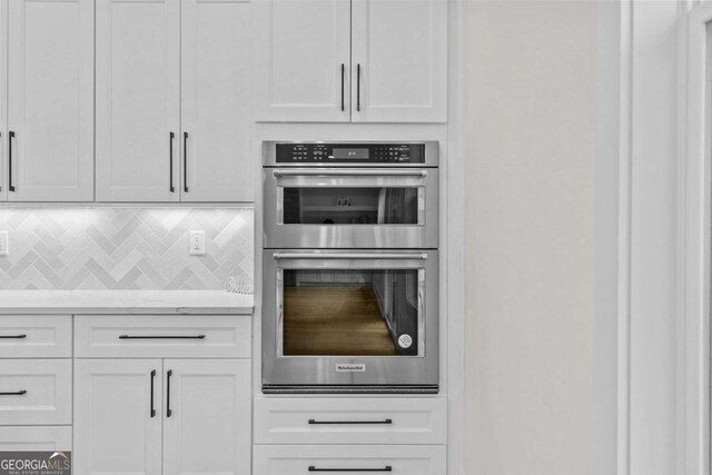 3636 Castoff Ct, Gainesville, GA 30506 - kitchen featuring double oven, tasteful backsplash, and white cabinets