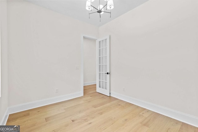 3636 Castoff Ct, Gainesville, GA 30506 - empty room featuring an inviting chandelier, baseboards, and wood finished floors