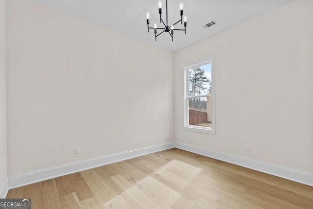 3636 Castoff Ct, Gainesville, GA 30506 - unfurnished dining area featuring visible vents, a notable chandelier, light wood-style flooring, and baseboards