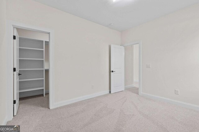 3636 Castoff Ct, Gainesville, GA 30506 - unfurnished bedroom with carpet, a walk in closet, and baseboards