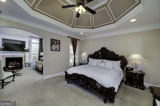 bedroom featuring arched walkways, multiple windows, carpet, and baseboards