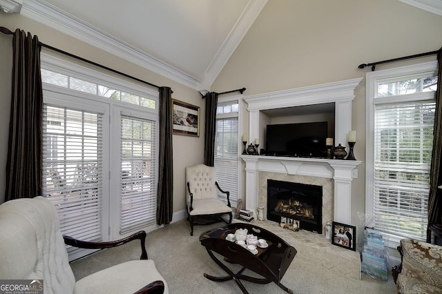 carpeted living room with high vaulted ceiling, ornamental molding, and a high end fireplace