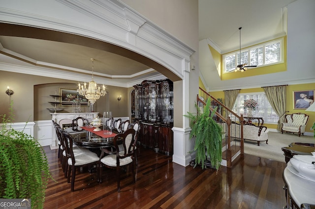 dining room with a wainscoted wall, ornamental molding, and wood finished floors