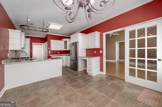 kitchen with a peninsula, a ceiling fan, backsplash, stainless steel fridge with ice dispenser, and crown molding