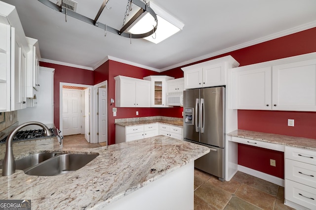 kitchen with crown molding, built in desk, stainless steel refrigerator with ice dispenser, white cabinets, and a sink