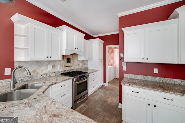 kitchen featuring stainless steel gas range oven, ornamental molding, white cabinetry, open shelves, and a sink