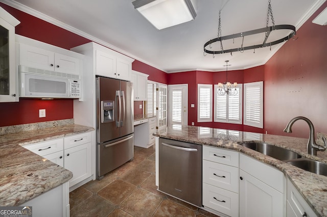 kitchen with a sink, white cabinetry, hanging light fixtures, ornamental molding, and appliances with stainless steel finishes