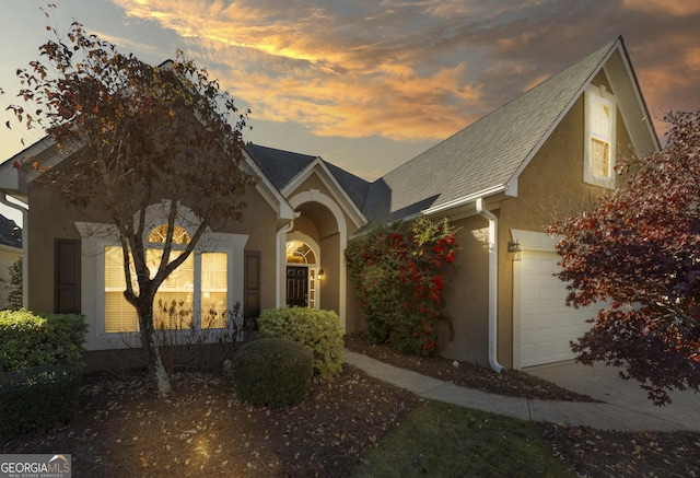 view of front of property with a garage and stucco siding