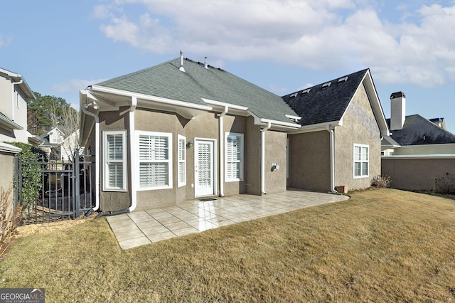 back of house with a patio area, a shingled roof, fence, and a yard