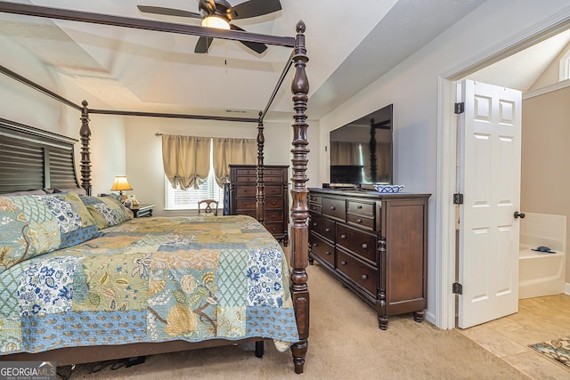 bedroom with ceiling fan, a raised ceiling, and light colored carpet