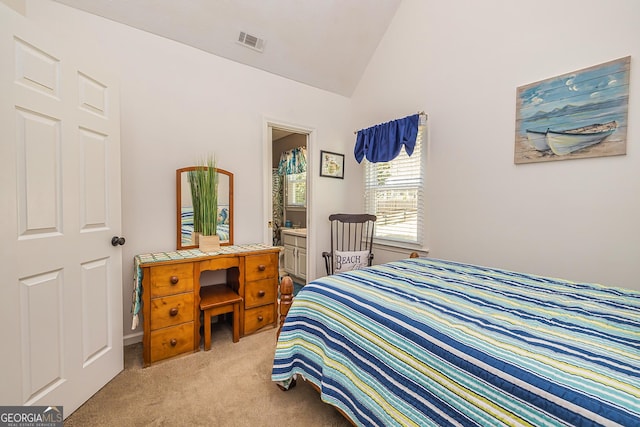 bedroom featuring visible vents, vaulted ceiling, carpet flooring, and ensuite bathroom