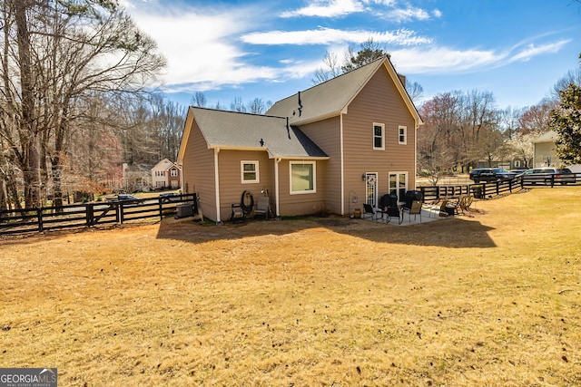 view of side of property featuring a lawn, a patio area, and fence