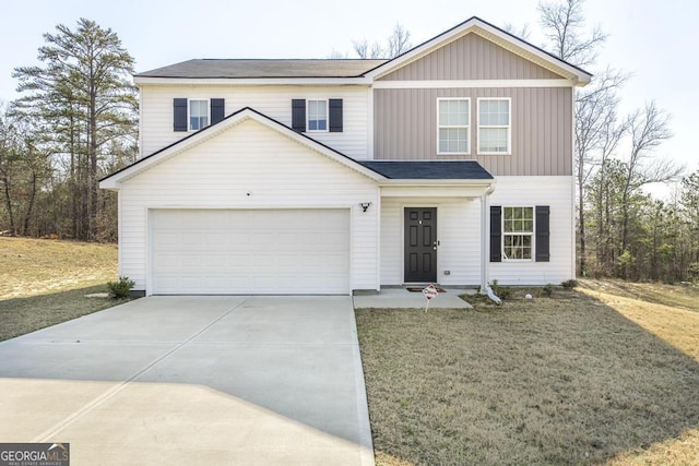 traditional-style house with driveway, an attached garage, and a front yard