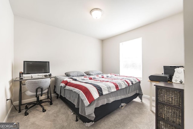 carpeted bedroom featuring baseboards