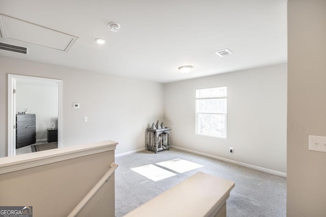 interior space with carpet floors, visible vents, and baseboards