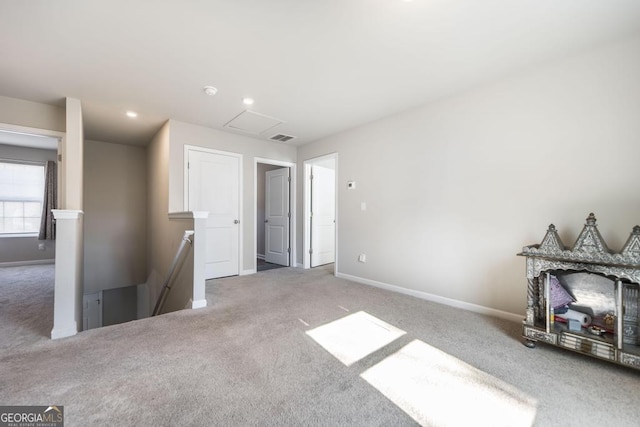 carpeted empty room with attic access, recessed lighting, visible vents, and baseboards