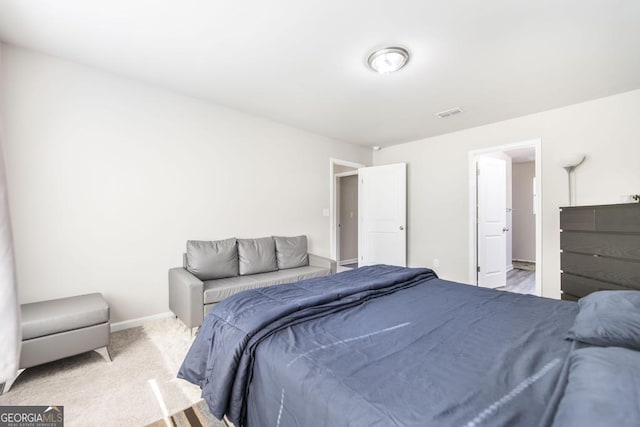 carpeted bedroom with visible vents and baseboards