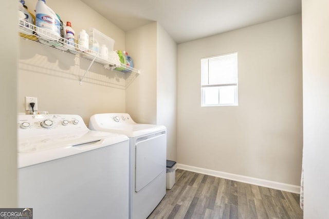 laundry area featuring laundry area, washer and clothes dryer, wood finished floors, and baseboards