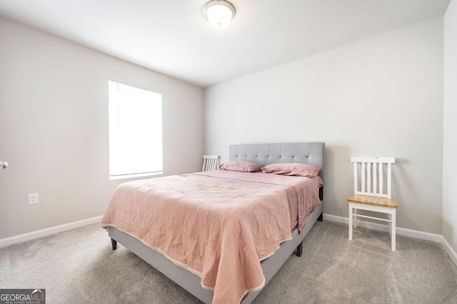 bedroom with carpet flooring and baseboards