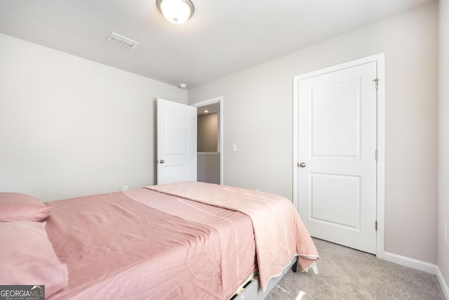 bedroom with light carpet, visible vents, and baseboards