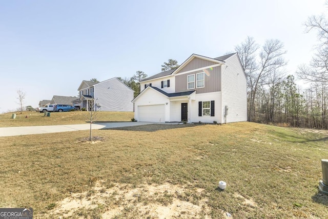 traditional home featuring a garage, concrete driveway, and a front yard