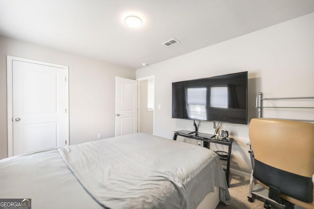 carpeted bedroom with visible vents and baseboards