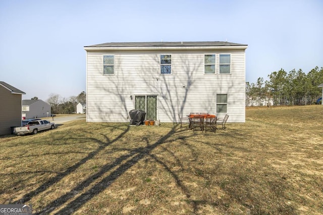 rear view of house with a lawn