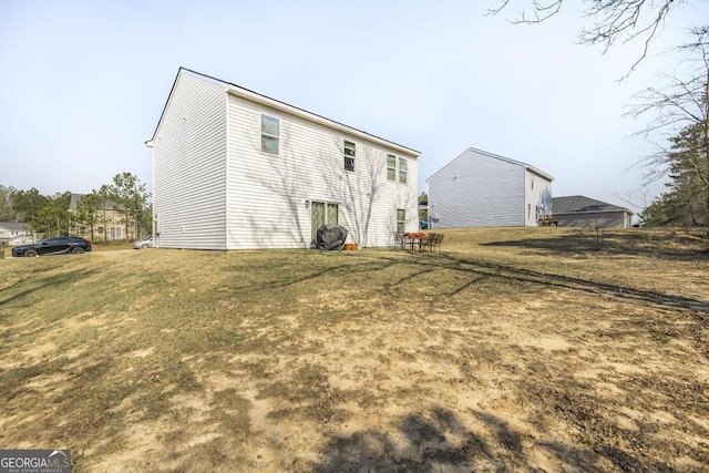 back of house featuring a lawn