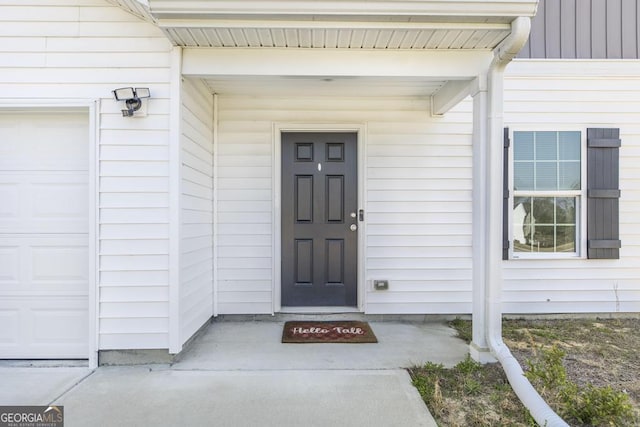 property entrance featuring an attached garage