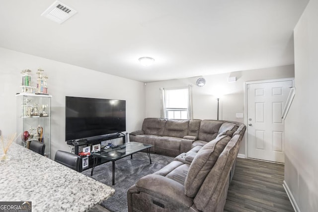 living room with baseboards, visible vents, and dark wood-style flooring