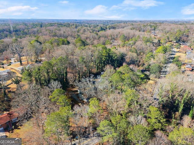 birds eye view of property featuring a wooded view