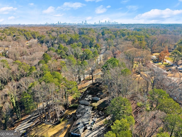 aerial view with a wooded view and a city view