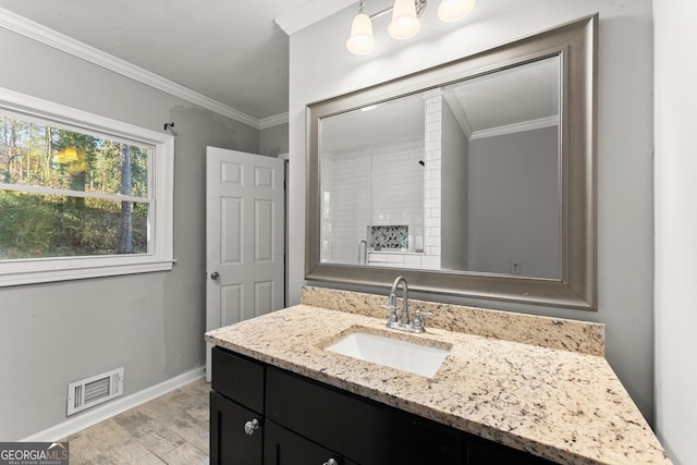 bathroom featuring baseboards, visible vents, walk in shower, crown molding, and vanity