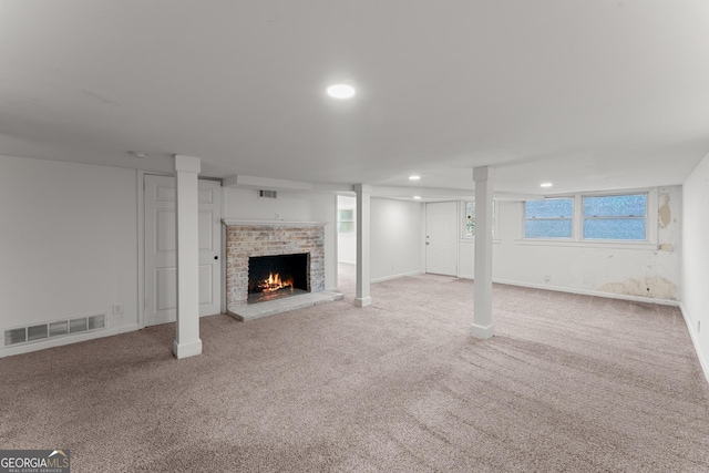 unfurnished living room featuring carpet floors, a fireplace, visible vents, and recessed lighting