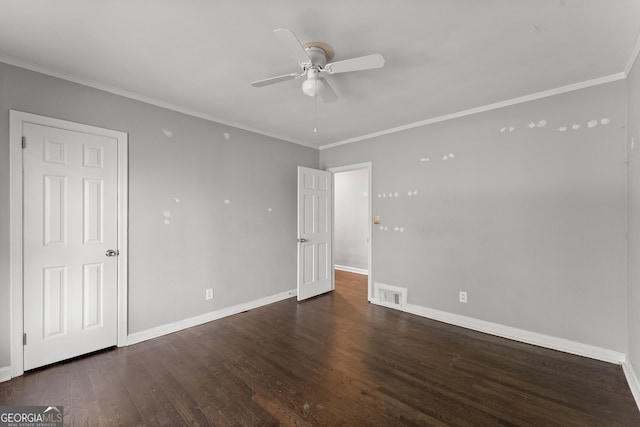 interior space featuring wood finished floors, a ceiling fan, baseboards, visible vents, and crown molding